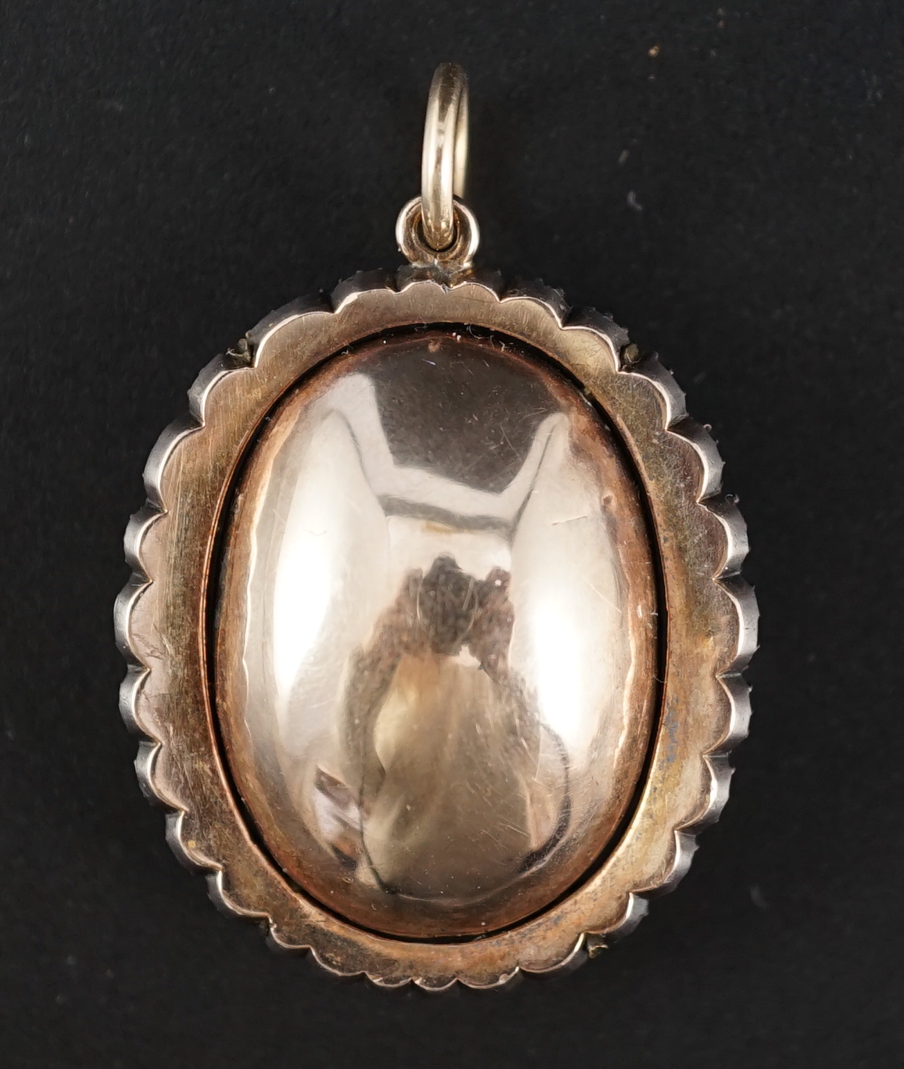 An early 19th century, gold and oval cut foil backed amethyst set pendant, with old cut diamond set border and closed back setting